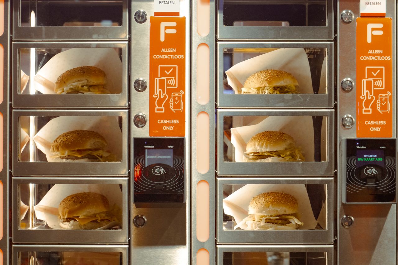 A modern vending machine dispensing hamburgers in Amsterdam, utilizing contactless payment technology.